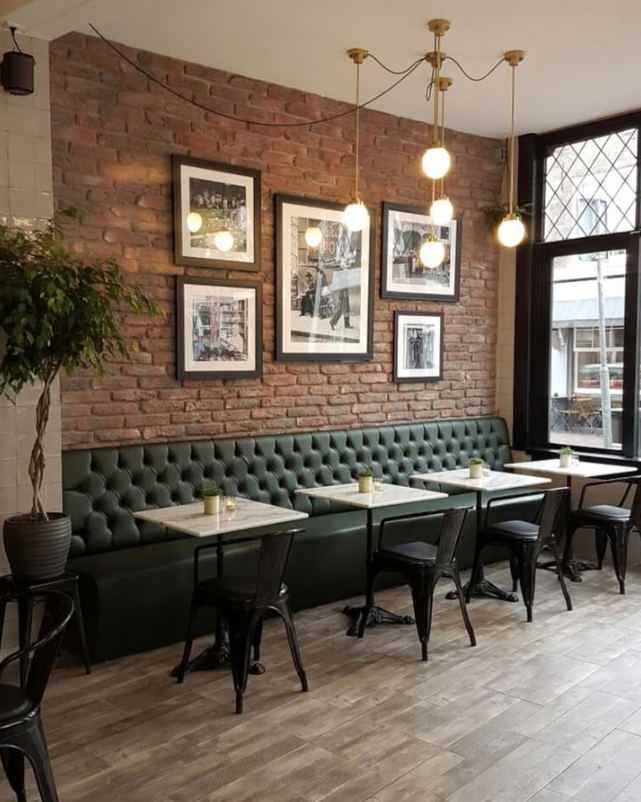Boutique cafe fitout with exposed brick and leather seating